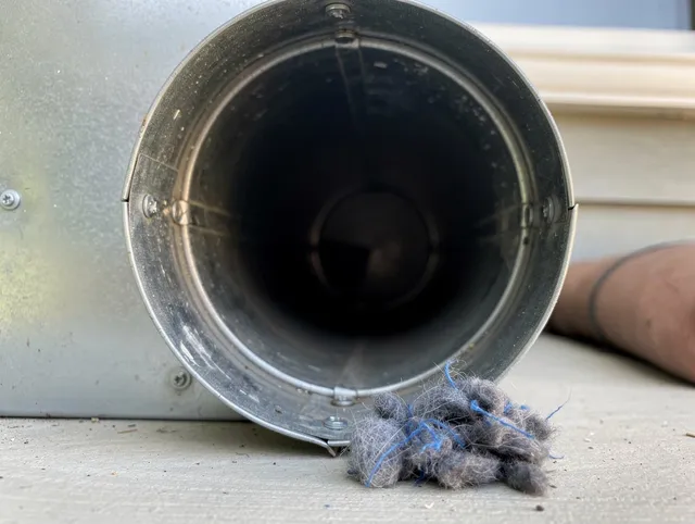 Mayfield Heights Dryer Vent Cleaning technician using specialized equipment to clear severe dryer vent blockage in Mayfield Heights